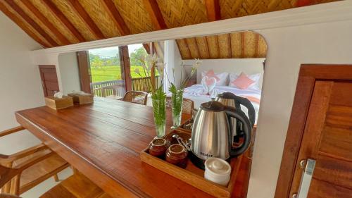 a room with a wooden table with a bed and a table sidx sidx at Lila Sari Guest House with breakfast in Penginyahan