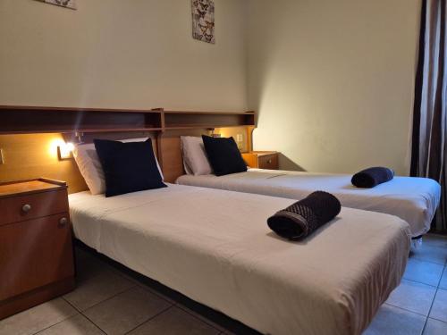 a hotel room with two beds with hats on them at Urban Chic Apartment Marsalforn in Marsalforn