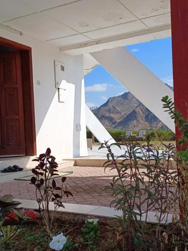 a view from the porch of a house with mountains in the background at Peace Farm in Hatta