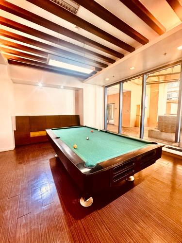 a billiard room with a pool table in it at New Condo at Grand Riviera Suites across US Embassy in Manila