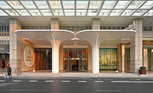 a large building with white columns and a glass ceiling at Oriental Riverside Bund View Hotel (Shanghai International Convention Center) in Shanghai