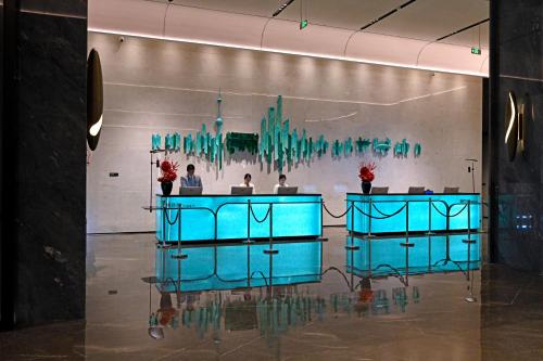 a lobby with blue tables and a wall at Oriental Riverside Bund View Hotel (Shanghai International Convention Center) in Shanghai