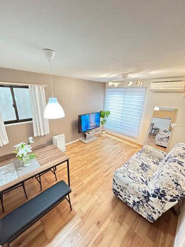 a living room with a couch and a table at Ueno new villa in Tokyo