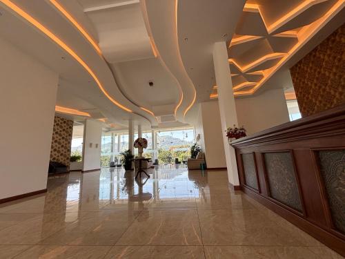 an empty lobby with a coffered ceiling and a staircase at The Marigold Hotel in Gampola