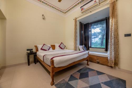 a bedroom with a bed and a window at The Countryside Resorts - Refined by Nature in Pushkar