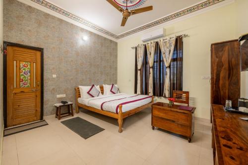 a bedroom with a bed and a table in it at The Countryside Resorts - Refined by Nature in Pushkar