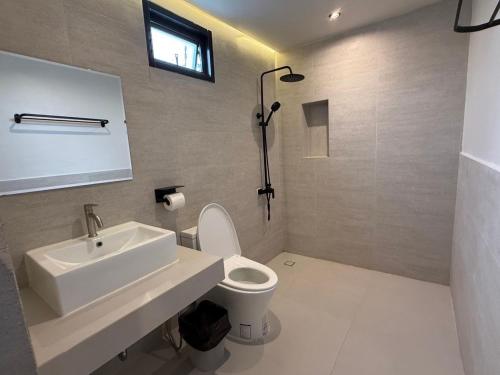 a bathroom with a sink and a toilet at Heaven space resort in Bang Sare