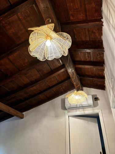 a chandelier hanging from the ceiling of a room at MASUA HOUSE PRESTIGE-two minutes from the sea in Nebida
