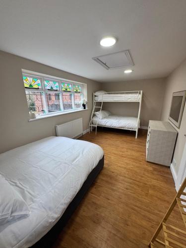 a bedroom with a bed and two bunk beds at Cosy Cloud in Congleton