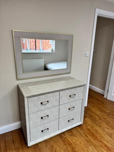 a dresser with a mirror on top of it at Cosy Cloud in Congleton