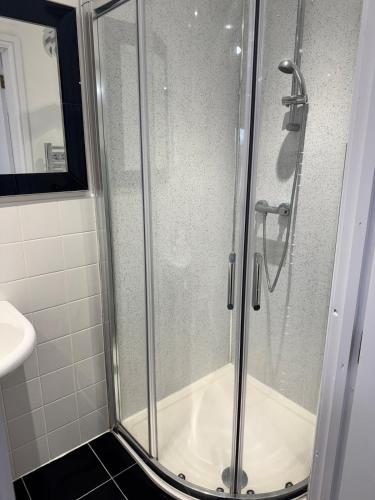 a shower with a glass door in a bathroom at Cosy Cloud in Congleton