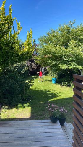 a view of a yard with a child playing in the grass at Charming Townhouse in the Heart of Haderslev in Haderslev