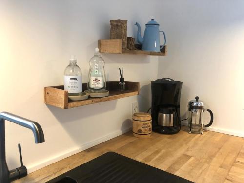 a kitchen with two bottles on a wall with a counter at Charming Townhouse in the Heart of Haderslev in Haderslev