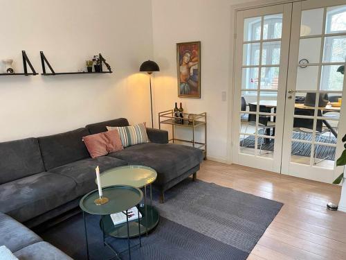 a living room with a couch and a table at Charming Townhouse in the Heart of Haderslev in Haderslev