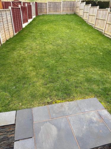 a backyard with a grass yard with a fence at Perfect bikers retreat or family get away in Monmouth
