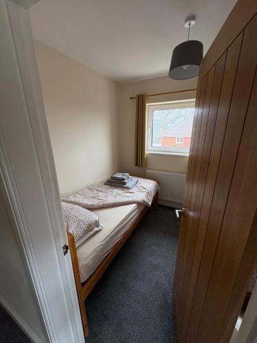 a small bedroom with a bed and a window at Perfect bikers retreat or family get away in Monmouth