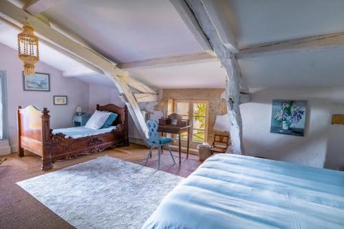 a bedroom with a bed and a desk in it at Propriété Le Monneton in Sainte-Christie