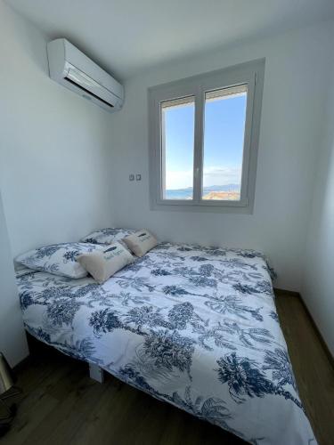 une chambre avec un lit et une fenêtre dans l'établissement Le Miramar La Vue, à Saint Cyprien Plage