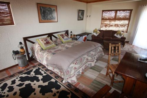 a bedroom with a bed and a living room at Lagoon Lodge in Walvis Bay