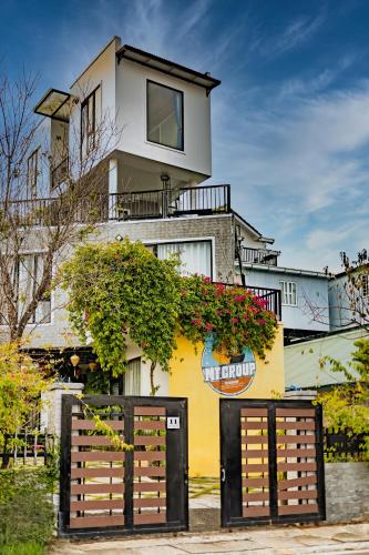 a building with two gates in front of it at Be Youth Villa Đà Lạt - O'TEL in Da Lat