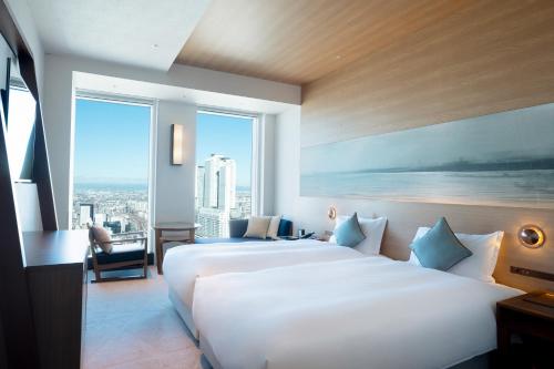 a hotel room with a large bed and a large window at Nagoya Prince Hotel Sky Tower in Nagoya