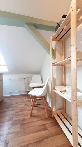 a room with bunk beds and a table and a chair at Good Stay Aparthotel mit kostenlosen Parkplätzen in Dresden
