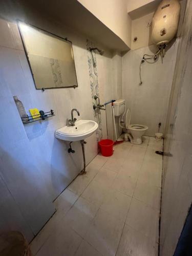 a bathroom with a sink and a toilet at Triveni Sangam Homestay in Prayagraj