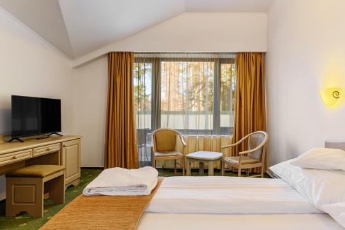 Ένα ή περισσότερα κρεβάτια σε δωμάτιο στο Hotel Casa Viorel jacuzzi & saunas