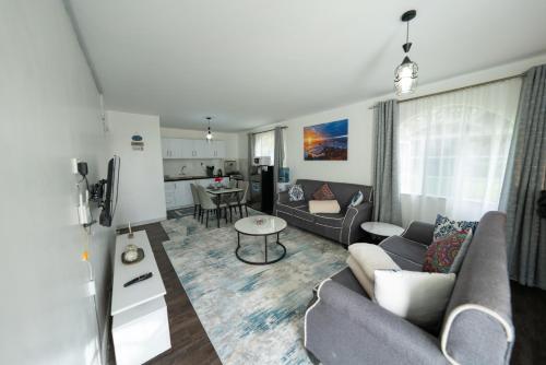 a living room with a couch and a table at Arabella Luxe Near Waterfront Mall - Karen in Nairobi