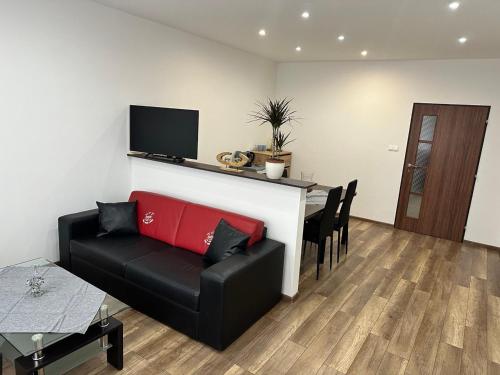 a living room with a couch and a table at Newly renovated 2 rooms apartment downtown Nitra in Nitra