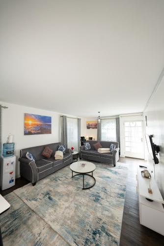 a living room with two couches and a table at Arabella Luxe Near Waterfront Mall - Karen in Nairobi