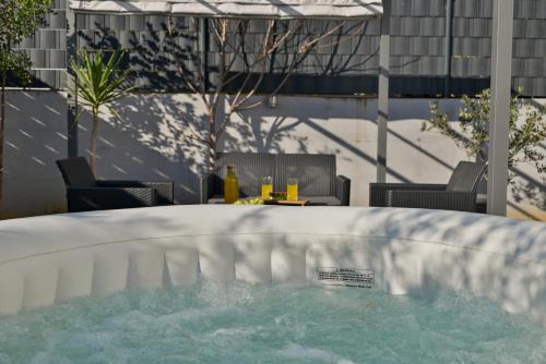 a swimming pool with a table and chairs in a patio at luxury apartment with garden jacuzzi and wellness in Trogir