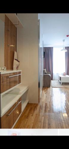 a kitchen and living room with a hard wood floor at Wolf Apartments Kopaonik in Kopaonik