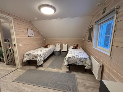 a room with two beds and a window at Villa Havu holiday home in Pyhä/Lapland in Pyhätunturi