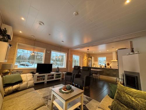 a living room with a couch and a table at Villa Havu holiday home in Pyhä/Lapland in Pyhätunturi