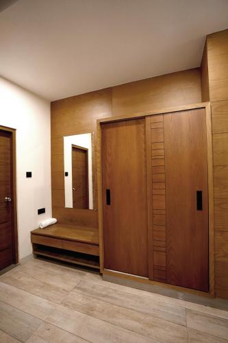 a bathroom with a wooden closet and a mirror at Stayon Hotels in Palakkad