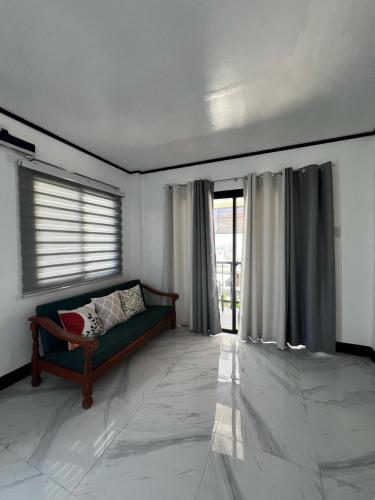 a living room with a couch and a window at Xavier's Place Coron in Coron