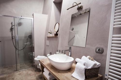 a bathroom with a sink and a toilet and a shower at Salcheto WineHouse in Montepulciano