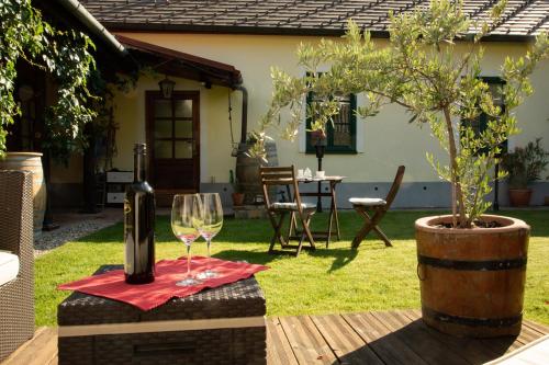 a wine glass sitting on a table in a yard at Frühstückspension Das Einser in Heiligenkreuz