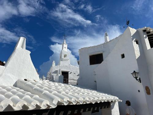 a white building with a roof and a church at Kasa K - Slowlife in Binibeca in Binibeca