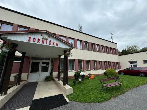 a building with a bench in front of it at Penzion Zornicka in Bardejovské Kúpele