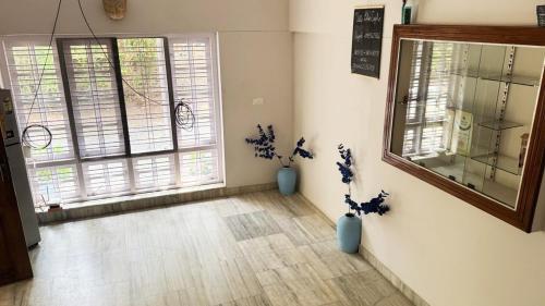 a room with two blue vases and two windows at Villa Blue Sophy in Varkala