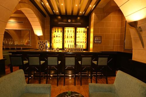 a bar with a bunch of chairs in a room at JAZ Dahabeya in Dahab