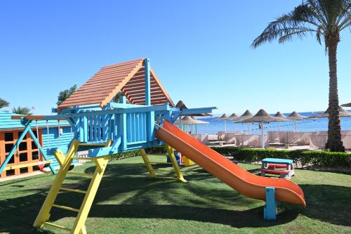a playground with a slide in front of a house at JAZ Dahabeya in Dahab