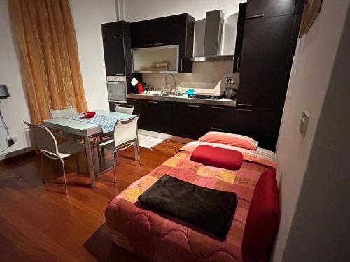 a bedroom with a bed and a table in a kitchen at Masc 26 in Bologna