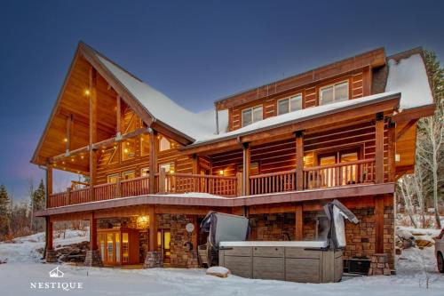 a large wooden house in the snow at 8992 STINGER DR DAVENPORT in Wanship