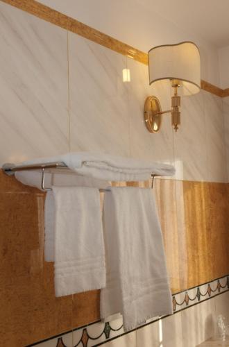 a bathroom with white towels on a towel rack at Hotel La Bussola in Novara