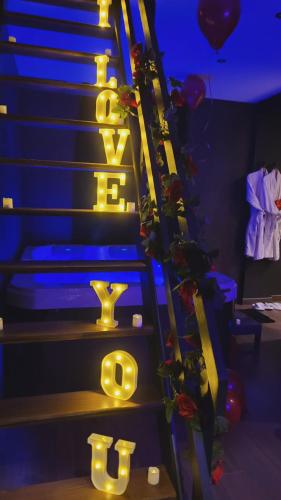a set of stairs with a sign that says exit at L'Escale Suite & Spa in Therdonne