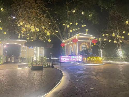 a park at night with lights and trees and a building at 哲帆民宿花园洋房江与城店 in Chongqing
