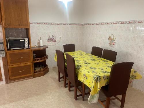 a dining room with a table and chairs and a microwave at Villa Saidia in Saidia 